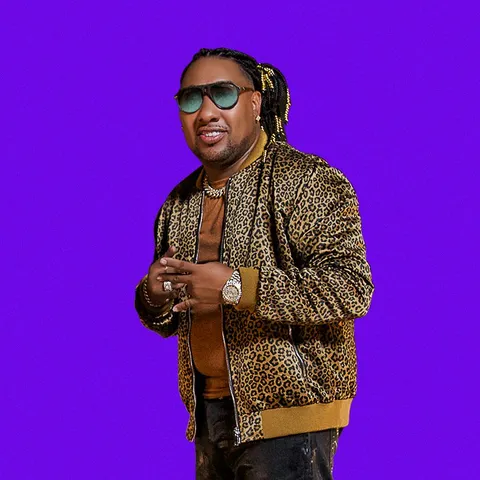 Baby Ranks in a leopard print jacket on a purple background