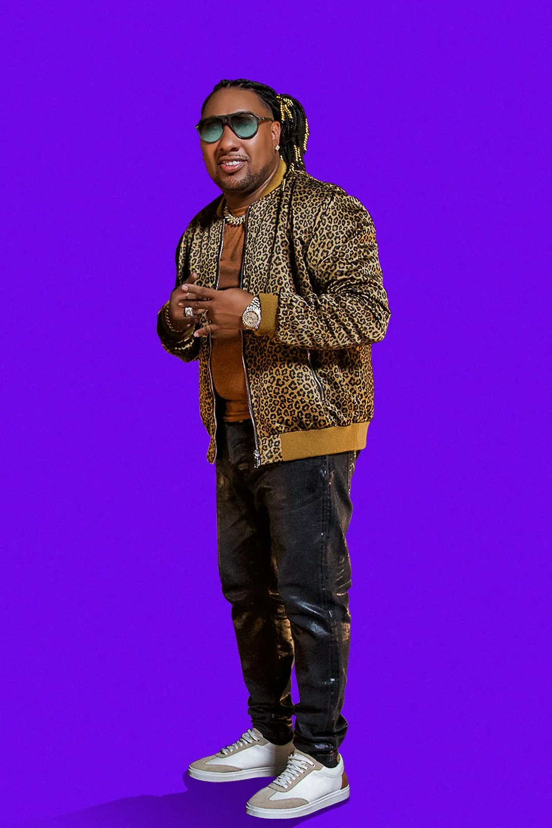 Baby Ranks in a leopard print jacket on a purple background